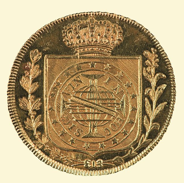 moeda com brasão gravado, louros ao redor do brasão, coroa acima do brasãi